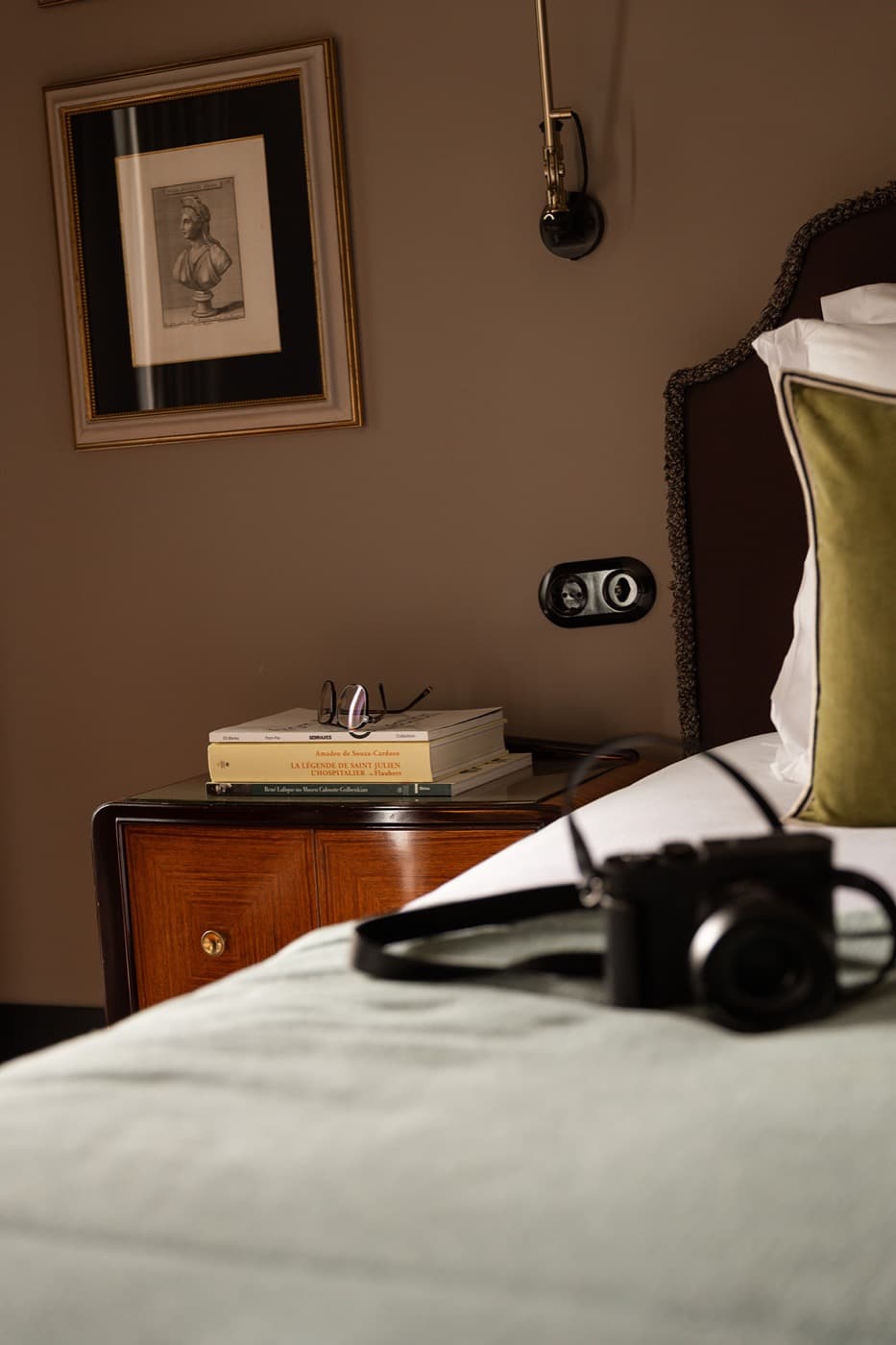 Books, reading glasses and a camera at a Lisboa bedside.