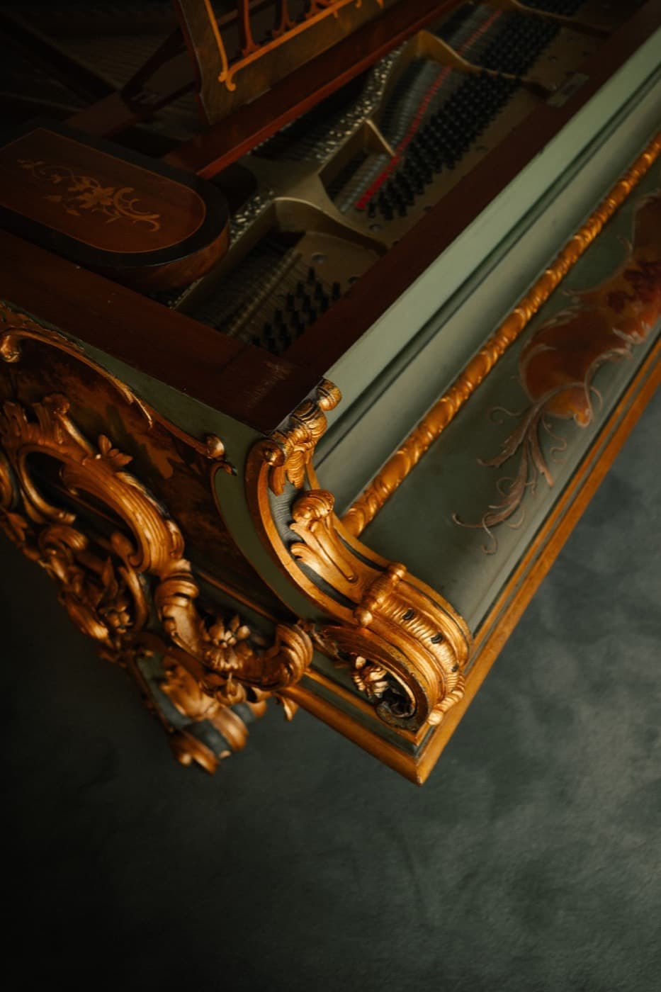 The gilded piano at Seteais, its strings open.